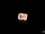 an image of a clear crystal on a black surface