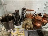 many copper pots and pans on display in a glass case