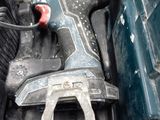 an image of a corded drill in the back of a truck