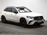 a white mercedes gle suv parked on a checkered floor
