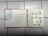 an open book with stamps on it sitting on a tiled floor