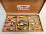 many different types of fishing lures in a wooden box