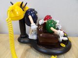 a figurine of a man and a woman on a phone