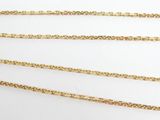 three gold chains on a white background