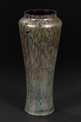 a vase that is sitting on a black surface