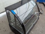 a glass display case that is sitting on the ground