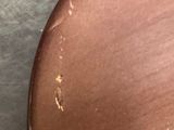 a close up of a brown chair with a brown seat