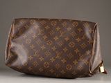a close up of a brown louis vuitton bag on a table