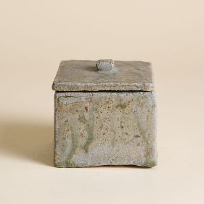 boîte en béton munie d'un couvercle, posée sur une surface plane
