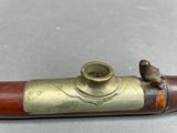 a small bird sitting on top of a brass pipe