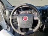 a dashboard of a car with a steering wheel and dashboard controls