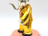 statue of an elephant in a gold suit with a pipe in its mouth