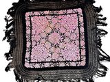 black and pink square rug with fringes on a white background