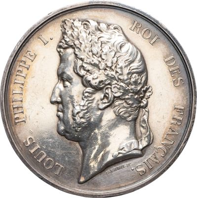 une vieille pièce d'argent sur laquelle figure le portrait d'un homme