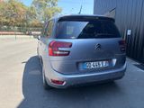 the back of a silver citrole parked in a parking lot