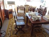 a table and chairs in a room with a rug on the floor