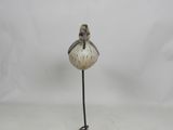a small bird on a metal stand with a white background