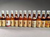 a group of bottles of wine sitting next to each other on a table