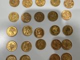 a close up of a pile of gold coins sitting on top of a table