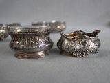 a silver bowl and a silver cup on a table