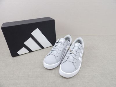 the adidas sneakers are white and grey with a black box in the background