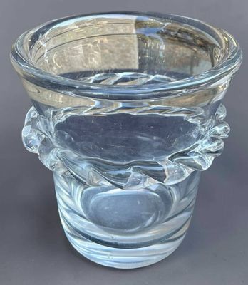 a clear glass vase with a leaf design on it