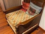 a chair with a pillow on it in a room