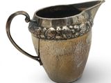 a silver pitcher on a white background with a white background