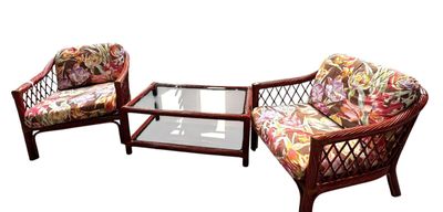 two wicker chairs and a coffee table on a white background