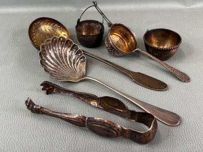 five spoons and two spoons sitting on a table