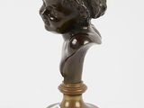 pair of bronze busts of a boy and a girl on marble bases
