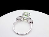 an image of a ring with a green stone in it