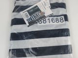 the shirt is striped in black and white and has a tag on it