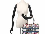the mannequin is holding a christian dior bag on a mannequin stand