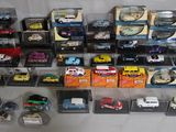 many different types of toy cars in the display case