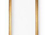 a gold picture frame on a white wall with a white background