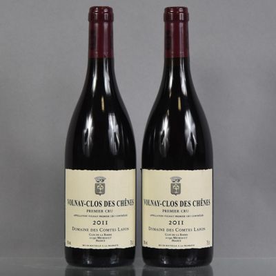 two bottles of wine sitting on top of a table next to each other