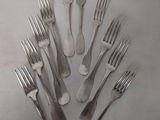a lot of forks arranged in a circle on a table