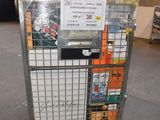 a metal cart with a sign on it in a warehouse