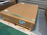 a cardboard box sitting on a pallet in a warehouse