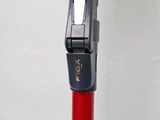a close up of a red pole with a cell phone attached to it