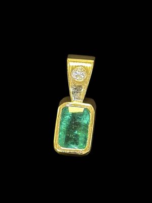 an emerald and diamond pendant on a black background