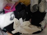 a cat that is laying in a bag of clothes