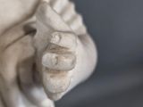a statue of a man holding a fish in his hands