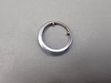 a close up of a silver ring on a table