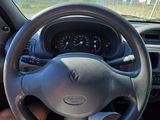 steering wheel of a car with a person sitting in the passenger seat