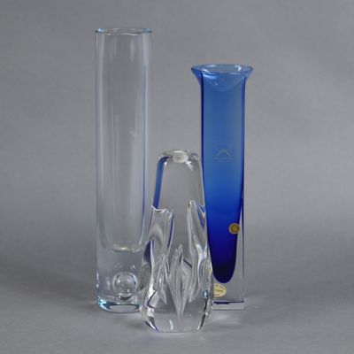 three glass vases sitting next to each other on a table