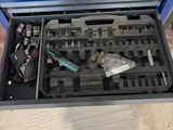 a tool box with tools in it sitting on the floor