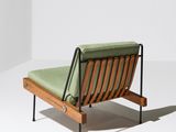 an image of a wooden chair with a green cushion on it