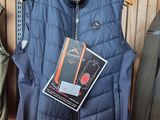 a blue vest hanging on a rack in a store